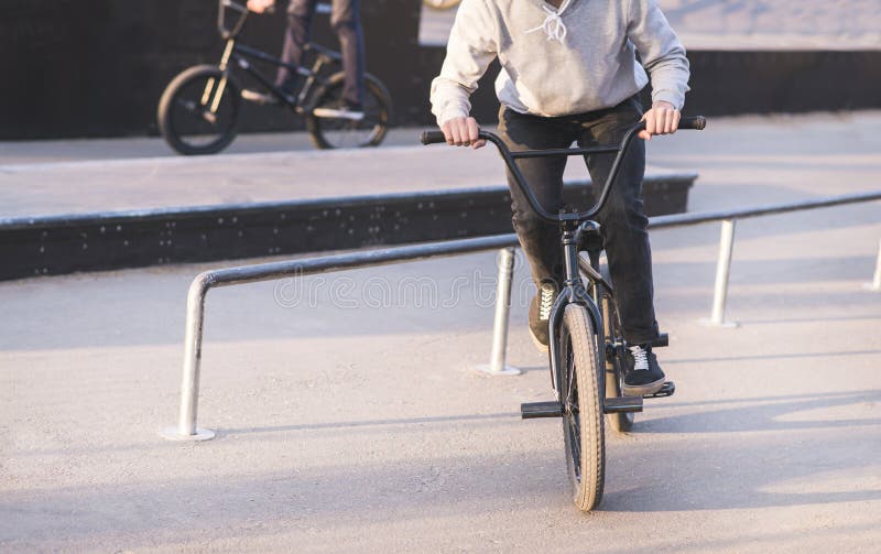 Group of Young People Riding a Skate Park on a Bmx Bike and Doing