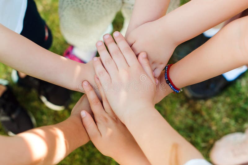 Group of young people`s hands. Team, teamwork, unity and friendship concept