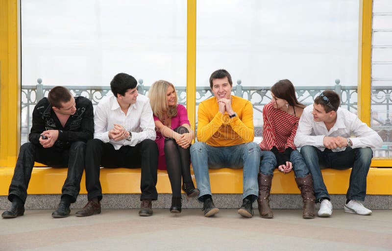 Group of young people sit