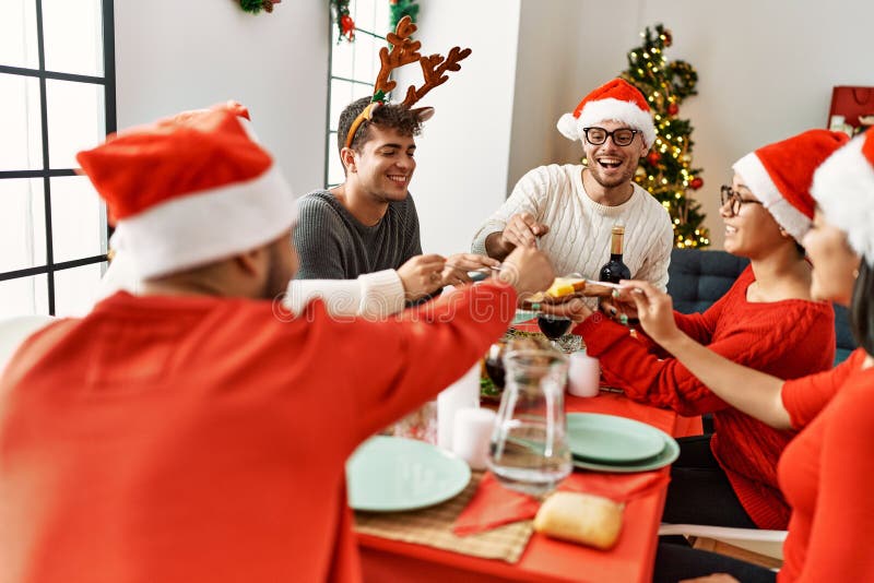 Group of Young People Smiling Happy Having Christmas Dinner at Home