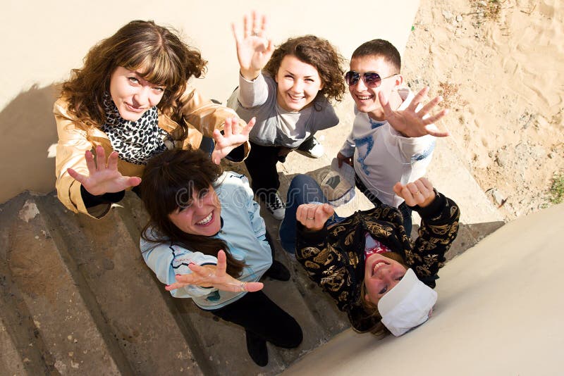 Group of young people standing under stairs