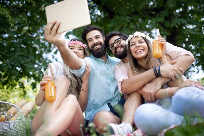 Group of young people taking a selfie outdoors, having fun stock photo Group of young people taking a selfie outdoors, having fun stock photo