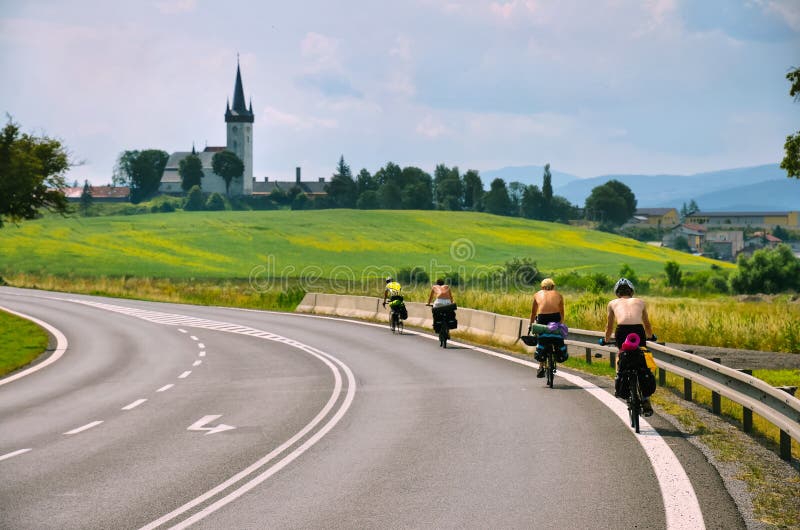 Group of young riders on bicycle ride near by famous castle in Slovakia. Boys are on long trip journey during summer holiday. Spis