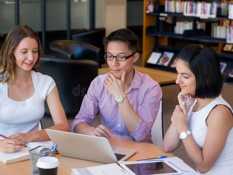 Group of young students at the library