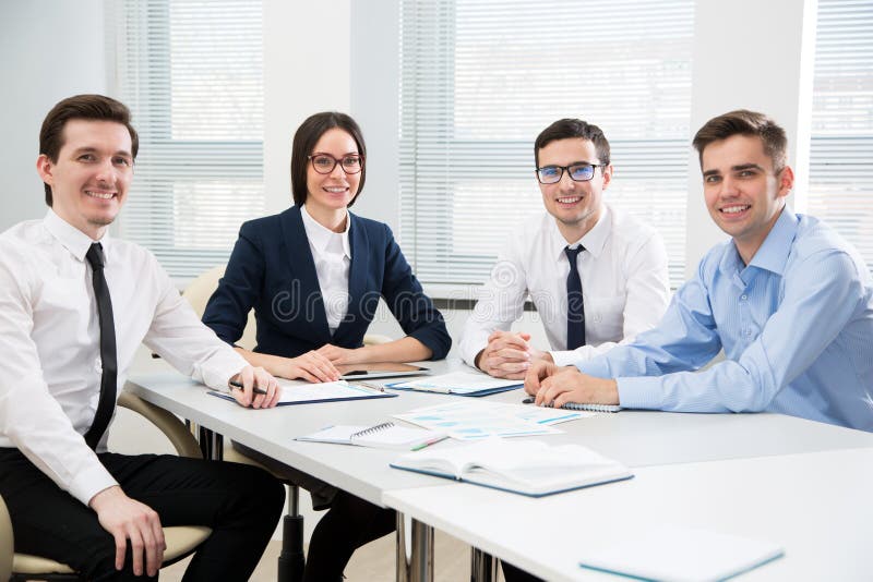 Group Young Successful Business People Sitting Around the Table in a