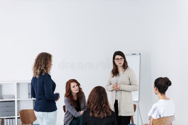 Group of young women talking sitting in a circle. Psychological support concept royalty free stock photography Group of young women talking sitting in a circle. Psychological support concept royalty free stock photography