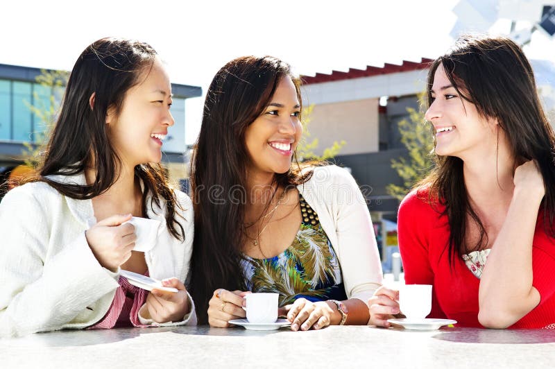 Group of girl friends sitting and having drinks at outdoor cafe. Group of girl friends sitting and having drinks at outdoor cafe