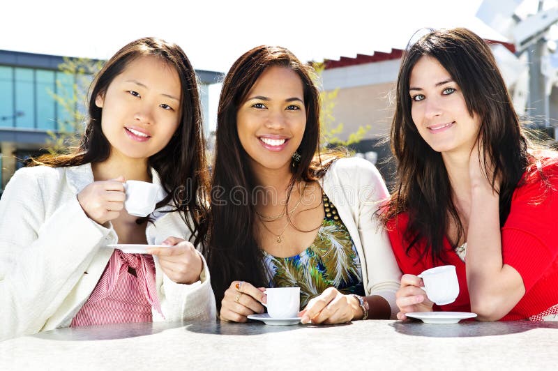 Group of girl friends sitting and having drinks at outdoor cafe. Group of girl friends sitting and having drinks at outdoor cafe