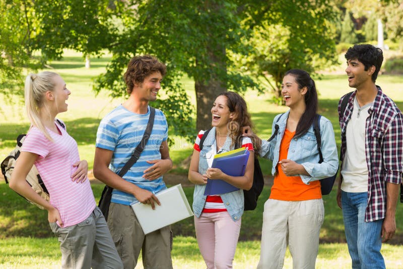 Group of cheerful college friends standing in the campus. Group of cheerful college friends standing in the campus