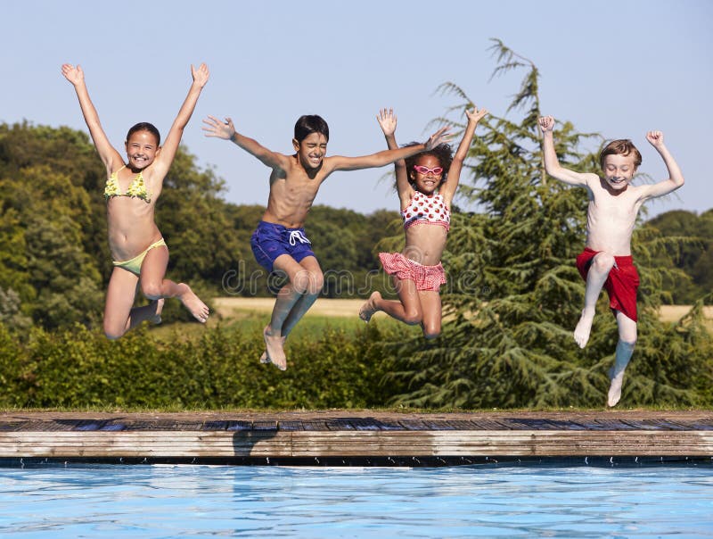 Groupe d'enfants sautant dans la piscine extérieure photo libre de droits Groupe d'enfants sautant dans la piscine extérieure photo libre de droits