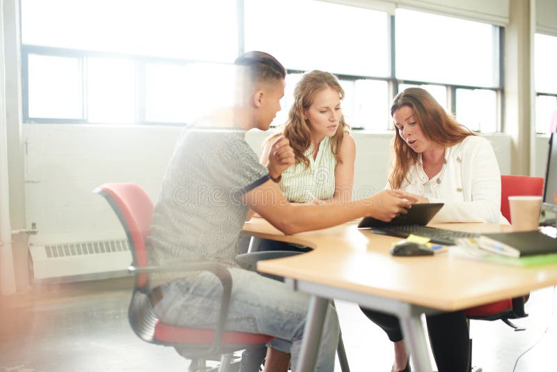 Groupe d'Unposed d'entrepreneurs créatifs d'affaires dans un bureau ouvert de concept faisant un brainstorm ensemble sur un compr photographie stock libre de droits Groupe d'Unposed d'entrepreneurs créatifs d'affaires dans un bureau ouvert de concept faisant un brainstorm ensemble sur un compr photographie stock libre de droits
