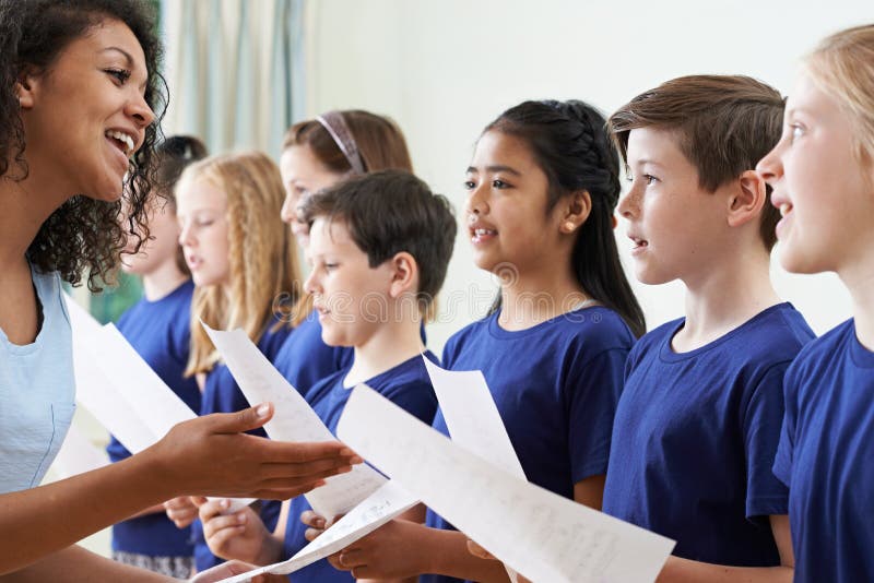 School Children With Teacher Singing In Choir. School Children With Teacher Singing In Choir