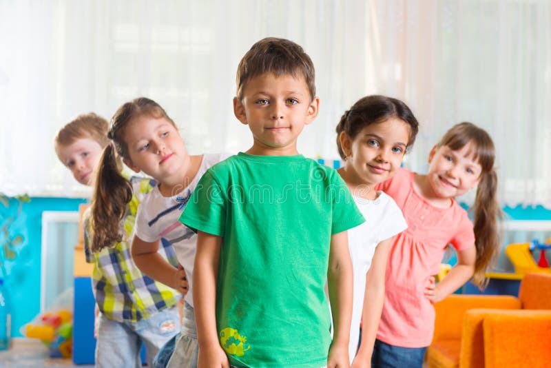 Group of five preschoolers standing in playroom. Group of five preschoolers standing in playroom