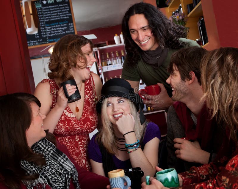 Group of six friends laughing over coffee. Group of six friends laughing over coffee