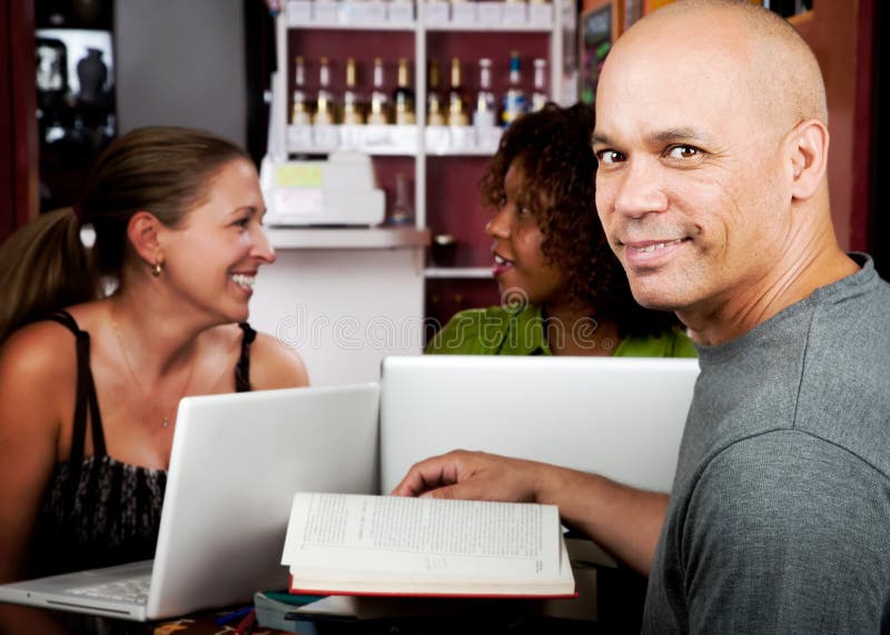 Diverse adult study group in coffee house. Diverse adult study group in coffee house