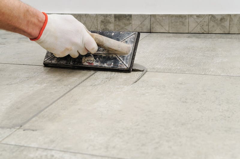Hand Applying Grout To Wall Tiles Stock Image Image of worker