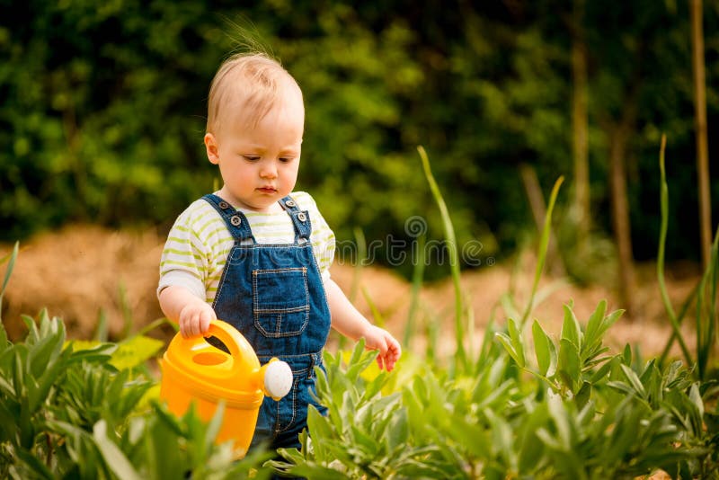 Growing plants - baby with watering can