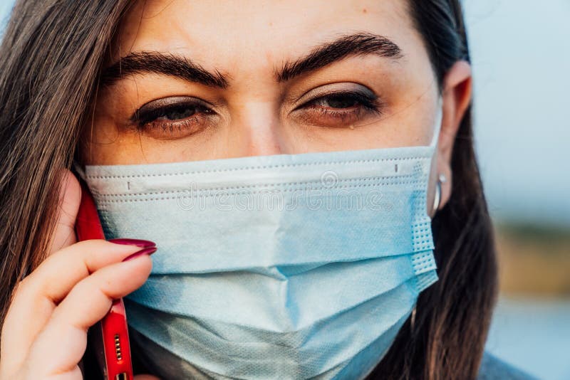 Großes Porträt einer jungen Frau in einer medizinischen Maske stockbild