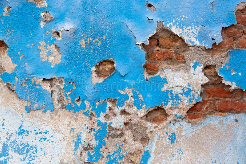 Grunge blue concrete cement wall with crack and bricks. Industrial building design and texture abstract architecture background