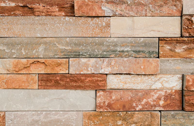 Grunge brown stone wall tiles texture. Wall panel natural brown,orange stone dirty,dust with pattern for architecture and interior stock photography