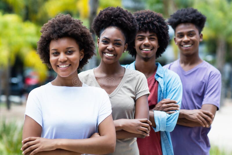Group of african american young women and men in line outdoor in the summer. Group of african american young women and men in line outdoor in the summer