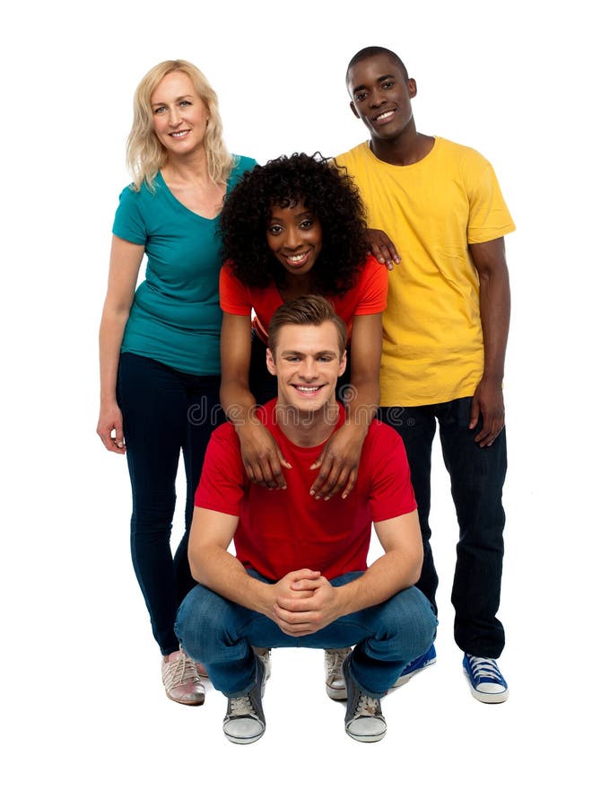 Group of four happy young people. Causal college mates posing in style. Group of four happy young people. Causal college mates posing in style