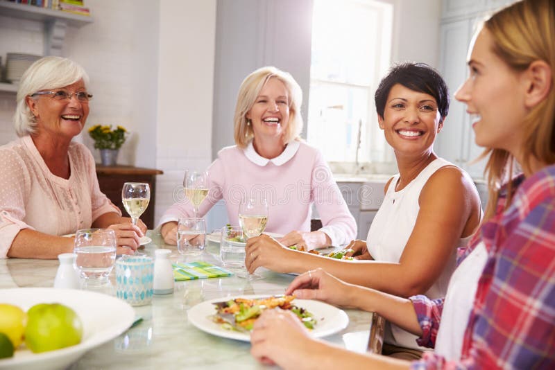 Group Of Mature Female Friends Enjoying Meal At Home. Group Of Mature Female Friends Enjoying Meal At Home