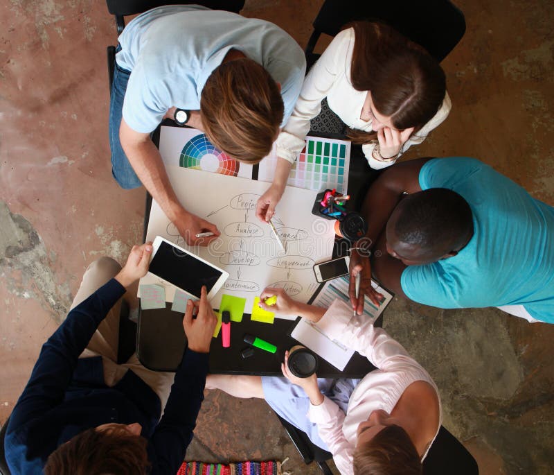 Group of business people working, top view. Loft office and smart casual dress code. Group of business people working, top view. Loft office and smart casual dress code