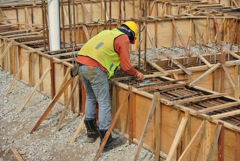 Grupa pracownicy budowlani zmyśla ziemi belkowatego formwork fotografia stock Grupa pracownicy budowlani zmyśla ziemi belkowatego formwork fotografia stock