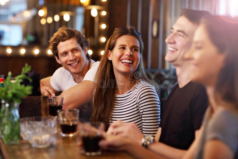 Group Of Young Friends Enjoying Meal In Restaurant. Group Of Young Friends Enjoying Meal In Restaurant