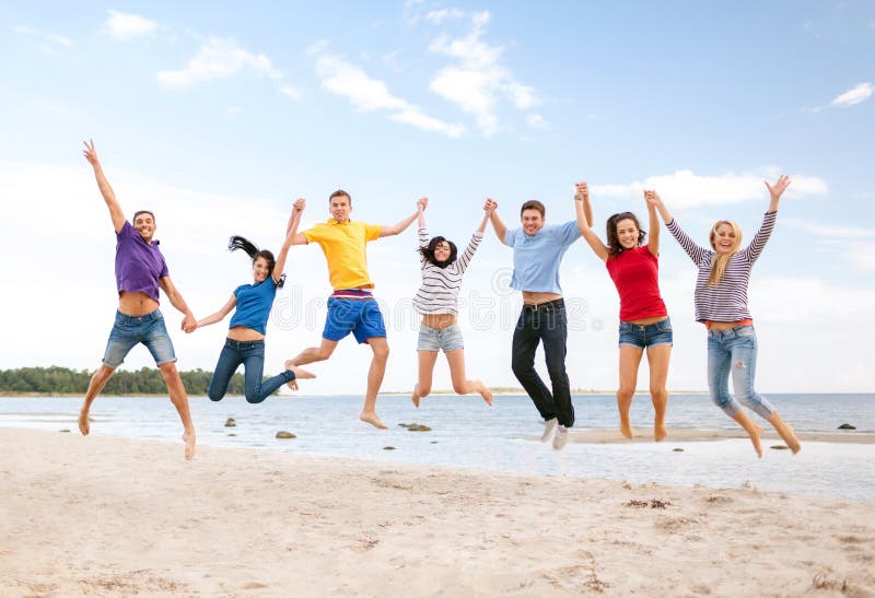 Summer, holidays, vacation, happy people concept - group of friends jumping on the beach. Summer, holidays, vacation, happy people concept - group of friends jumping on the beach.