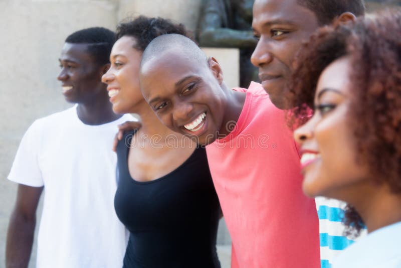 Group of relaxing african american men and women outdoors. Group of relaxing african american men and women outdoors