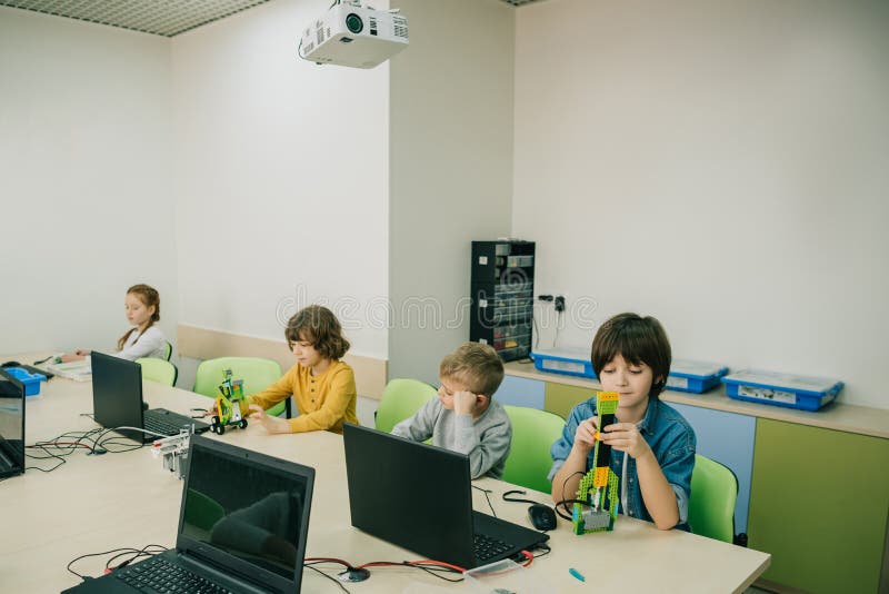 Grupa skupiający się dzieciaki pracuje na projektach przy trzonem obrazy stock