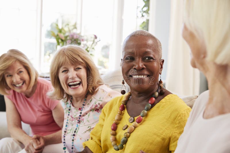 Group Of Senior Female Friends Relaxing On Sofa At Home. Group Of Senior Female Friends Relaxing On Sofa At Home