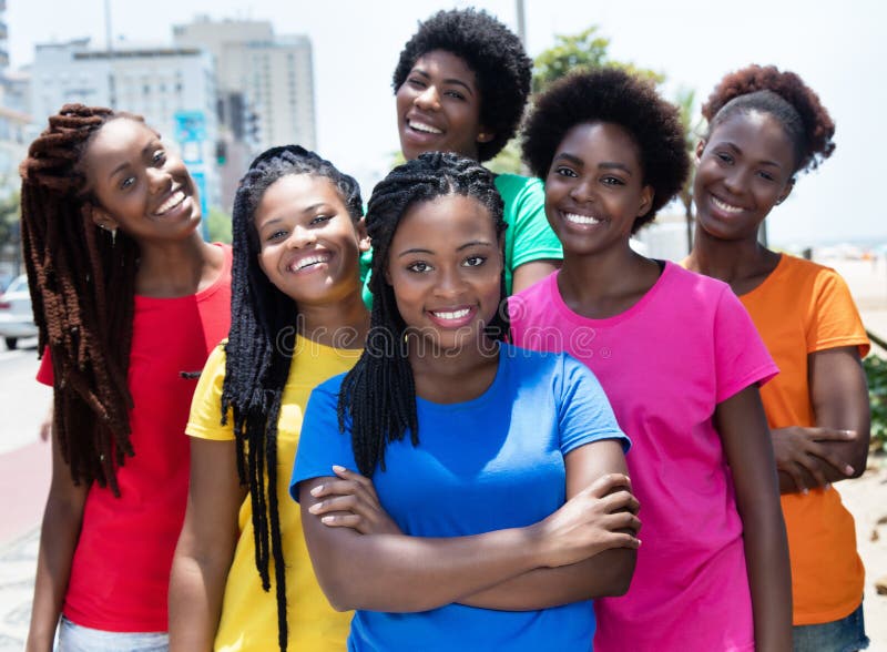 Group of six laughing african american women in colorful shirts in the summer in the city. Group of six laughing african american women in colorful shirts in the summer in the city