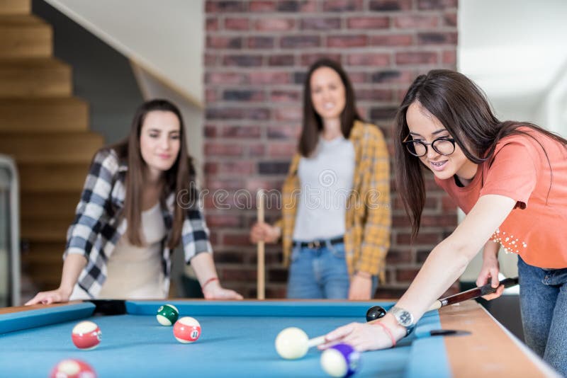 Grupo de amigos felizes desfrutando de jogo de bilhar, companhia