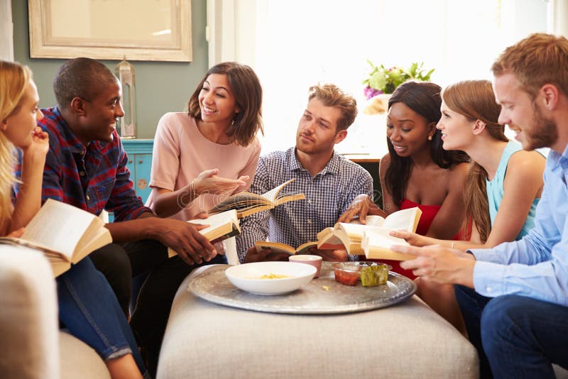 Group Of Friends Taking Part In Book Club At Home. Group Of Friends Taking Part In Book Club At Home