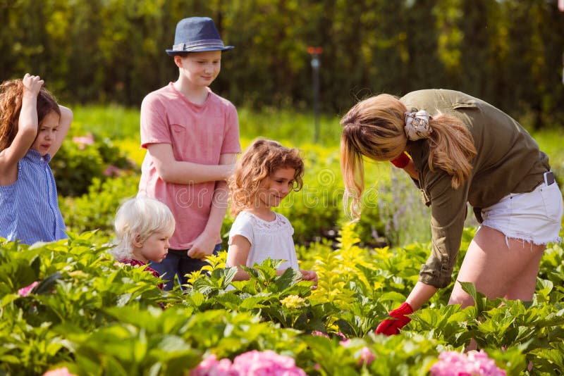 Group of kids at the excursion at the flower garden park. Group of kids at the excursion at the flower garden park