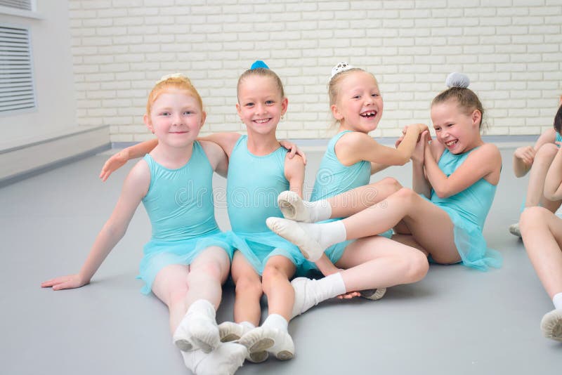 Grupo de pequeños bailarines de ballet lindos que se divierten en la clase de escuela de danza foto de archivo Grupo de pequeños bailarines de ballet lindos que se divierten en la clase de escuela de danza foto de archivo