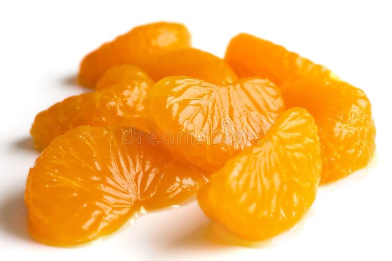 Group of mandarin segments in light syrup on white. Group of mandarin segments in light syrup on white.