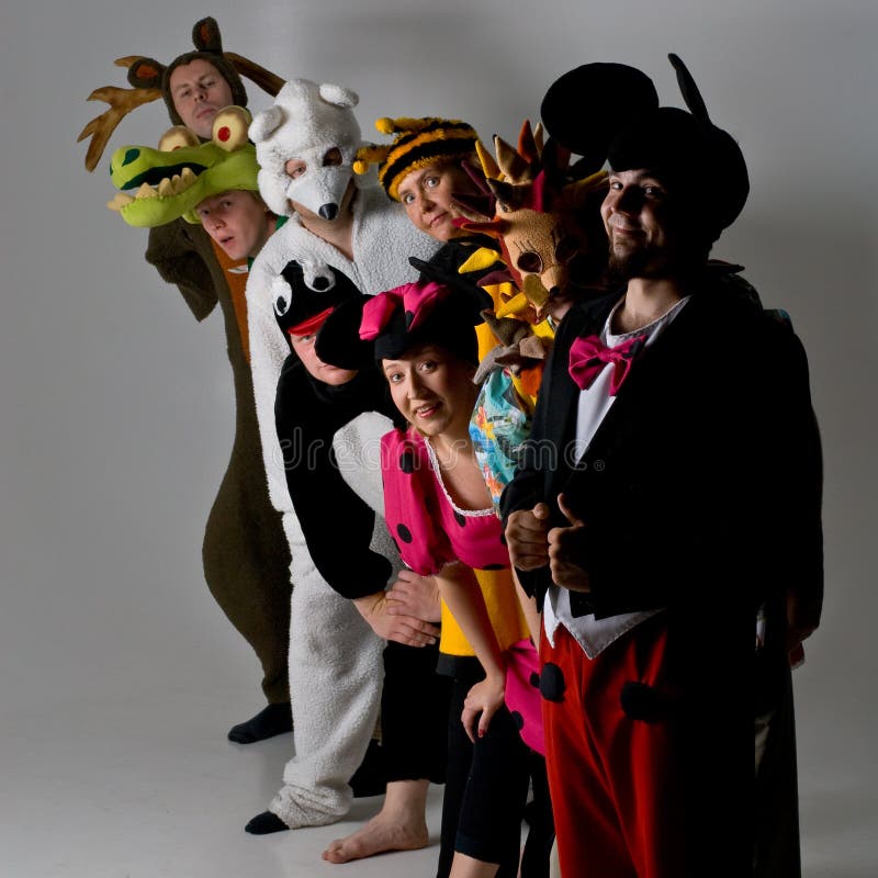 Group of theater performers in various animal costumes lined up in a row. Group of theater performers in various animal costumes lined up in a row.