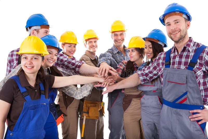 Diverse group of construction workers stacking hands. Isolated on white. Diverse group of construction workers stacking hands. Isolated on white