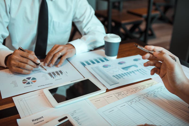 Group of business people analysis summary graph reports of business operating expenses and work data about the company`s financial statements. Group of business people analysis summary graph reports of business operating expenses and work data about the company`s financial statements.