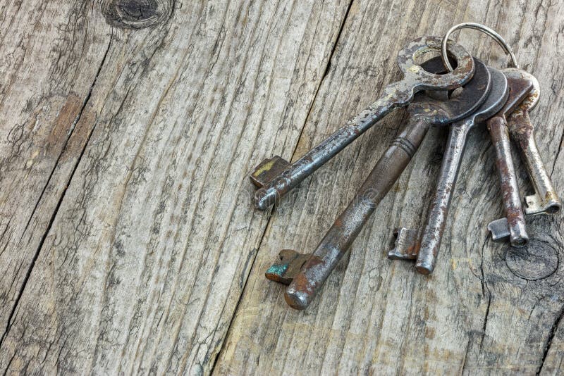 Bunch of different old rusty keys on dark wooden background. Bunch of different old rusty keys on dark wooden background