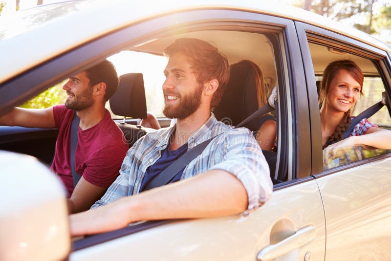 Group Of Friends In Car On Road Trip Together. Group Of Friends In Car On Road Trip Together