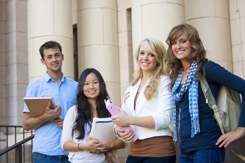 Young, attractive male and female students outside an academic building. Young, attractive male and female students outside an academic building