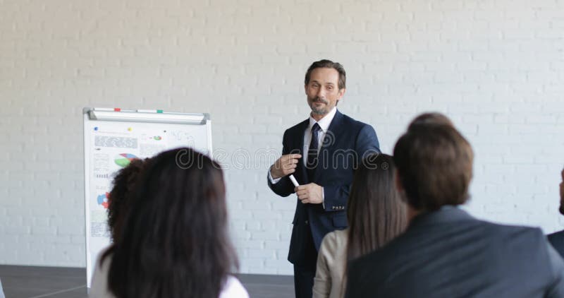 Gruppe Geschäftsleute auf Darstellung in Konferenz-Hall Listening To Successful Businessman-Fortbildungsseminar