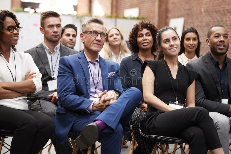 Gruppe Geschäftsmänner und Geschäftsfrauen, die auf Darstellung bei der Konferenz hören stockfoto Gruppe Geschäftsmänner und Geschäftsfrauen, die auf Darstellung bei der Konferenz hören stockfoto