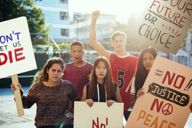 Group of teenagers protesting demonstration holding posters antiwar justice peace concept. Group of teenagers protesting demonstration holding posters antiwar justice peace concept