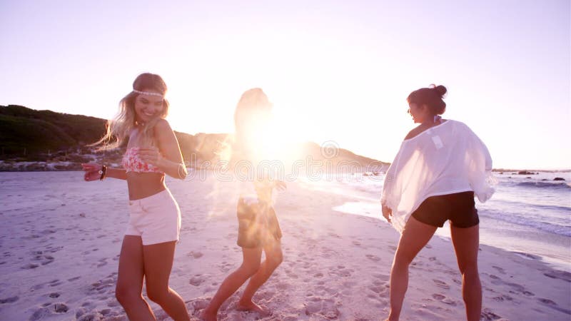 Gruppe junge Frauen, die auf den Strand tanzen